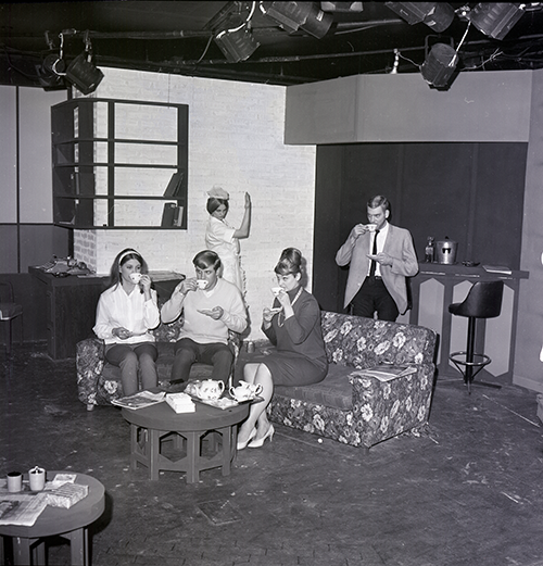 College students sit on a couch and drink tea