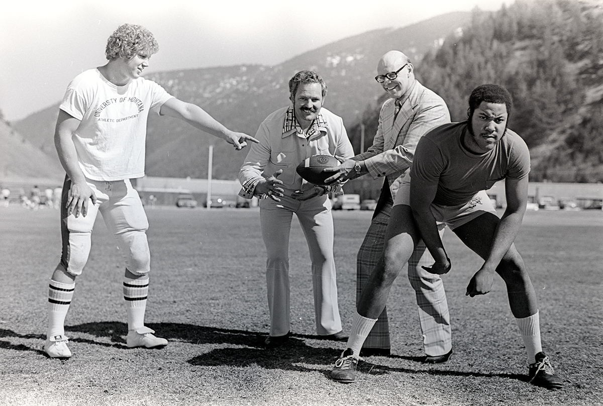 Four men at Washington-Grizzly Stadium, circa 1970s.
