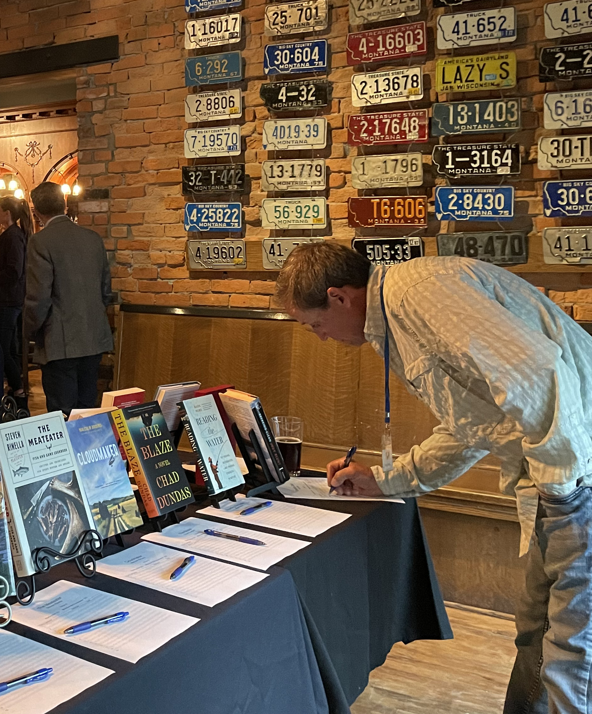 A guest at Writers on Water bids on books during the silent auction.