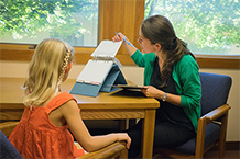 A psychologist works with a child.